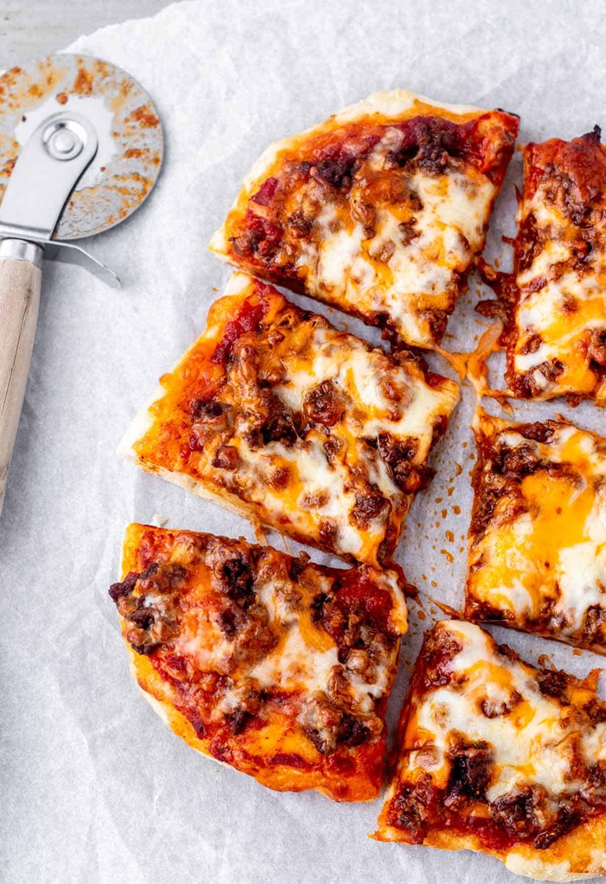 Slices of Mexican fiestada pizzas on a table.