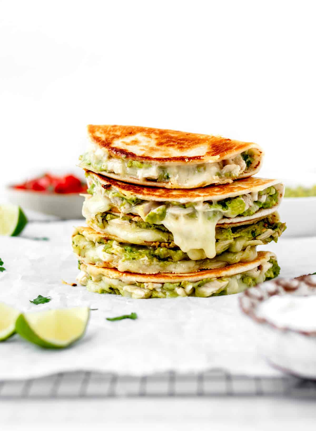 Mini chicken and avocado quesadillas stacked on top of one another.