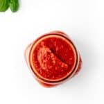 An overhead image of a jar with hidden vegetable pasta sauce.