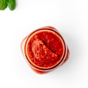 An overhead image of a jar with hidden vegetable pasta sauce.