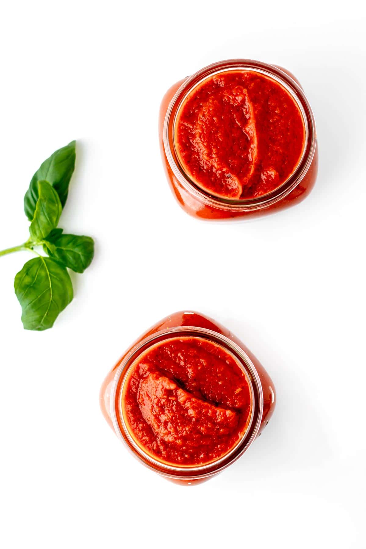 Hidden veggie pasta sauce in two clear glass jars.