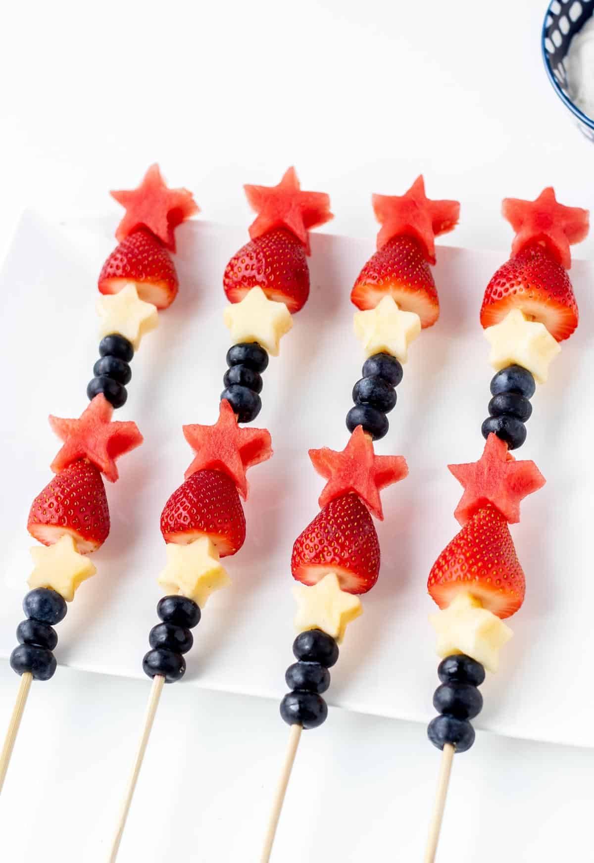 4th of July skewers assembled and lying on a white platter.