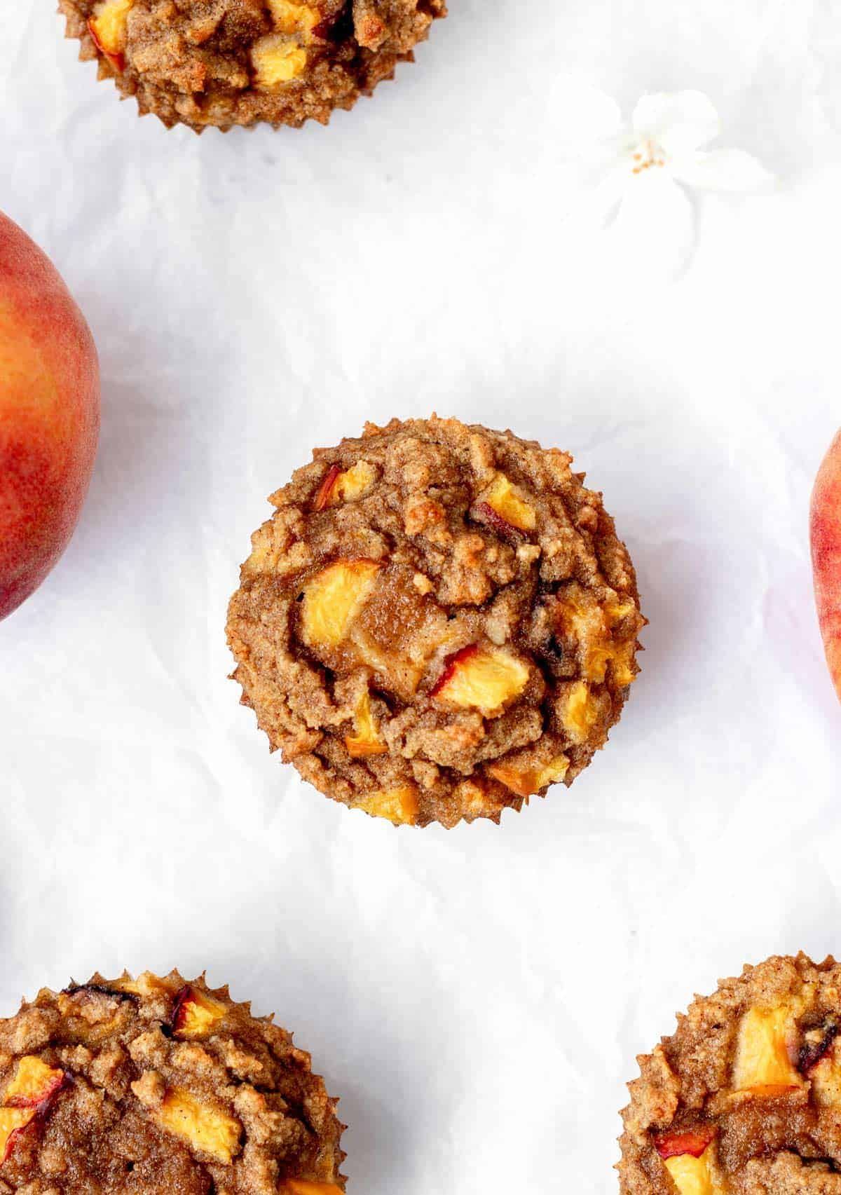 Overhead image of gluten-free peach muffins on parchment paper.