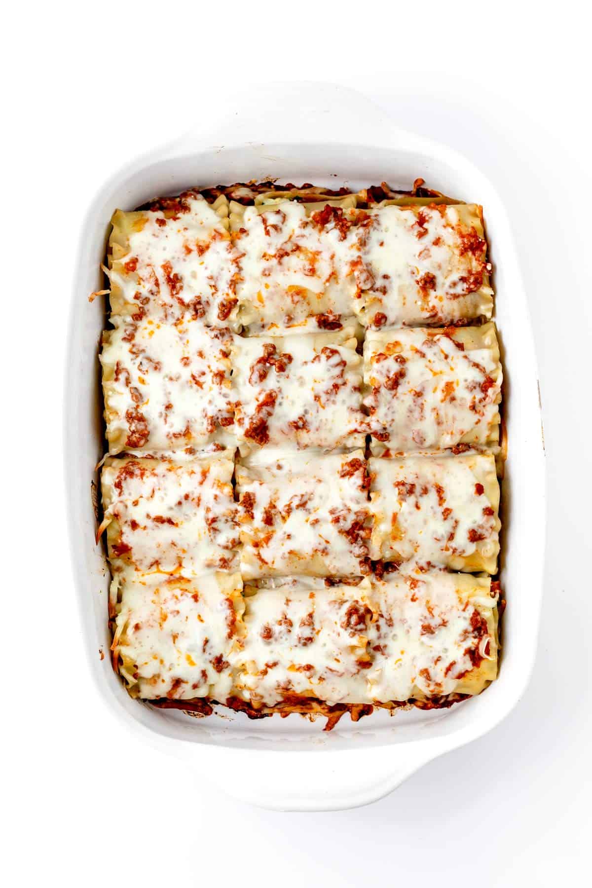 Lasagna rollups with melted cheese on top after baking.