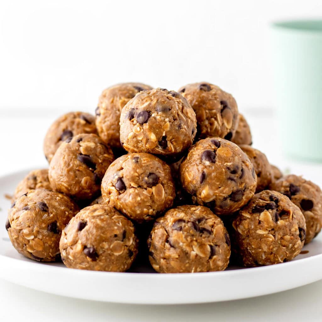 A stack of nut free energy balls on a plate.