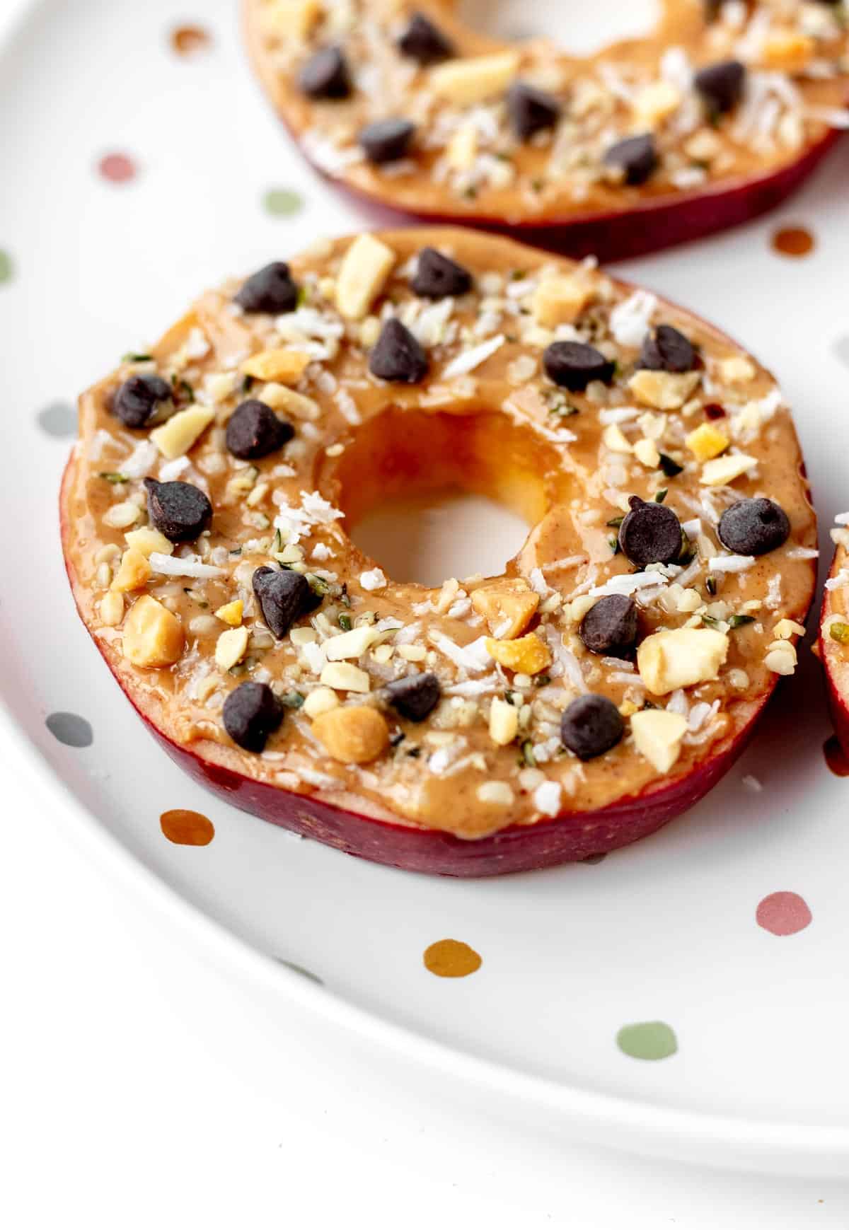 A close-up of a fully assembled apple slice cookie on a plate.