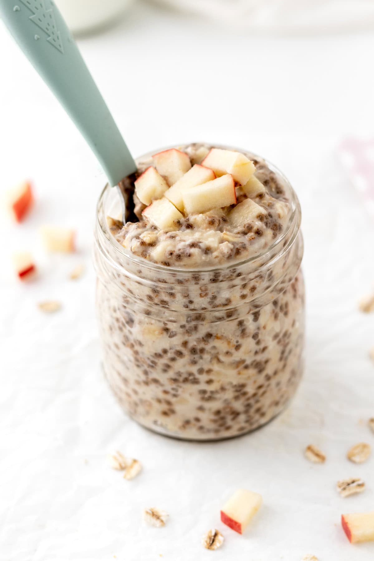 Healthy applesauce overnight oats in a glass jar on the counter.