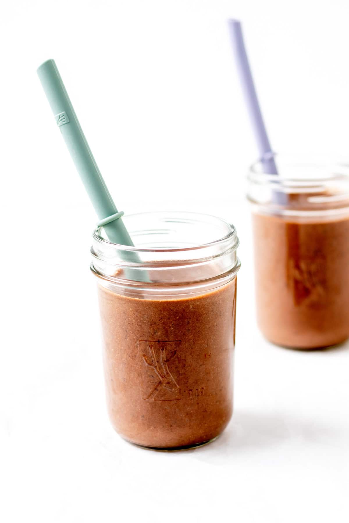 Two chocolate black bean and banana smoothies on a counter.