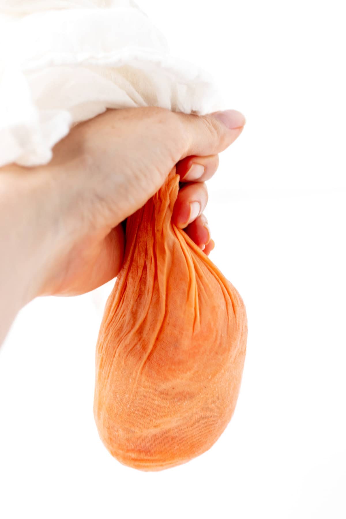 Squeezing the moisture out of the carrots with a hand towel.