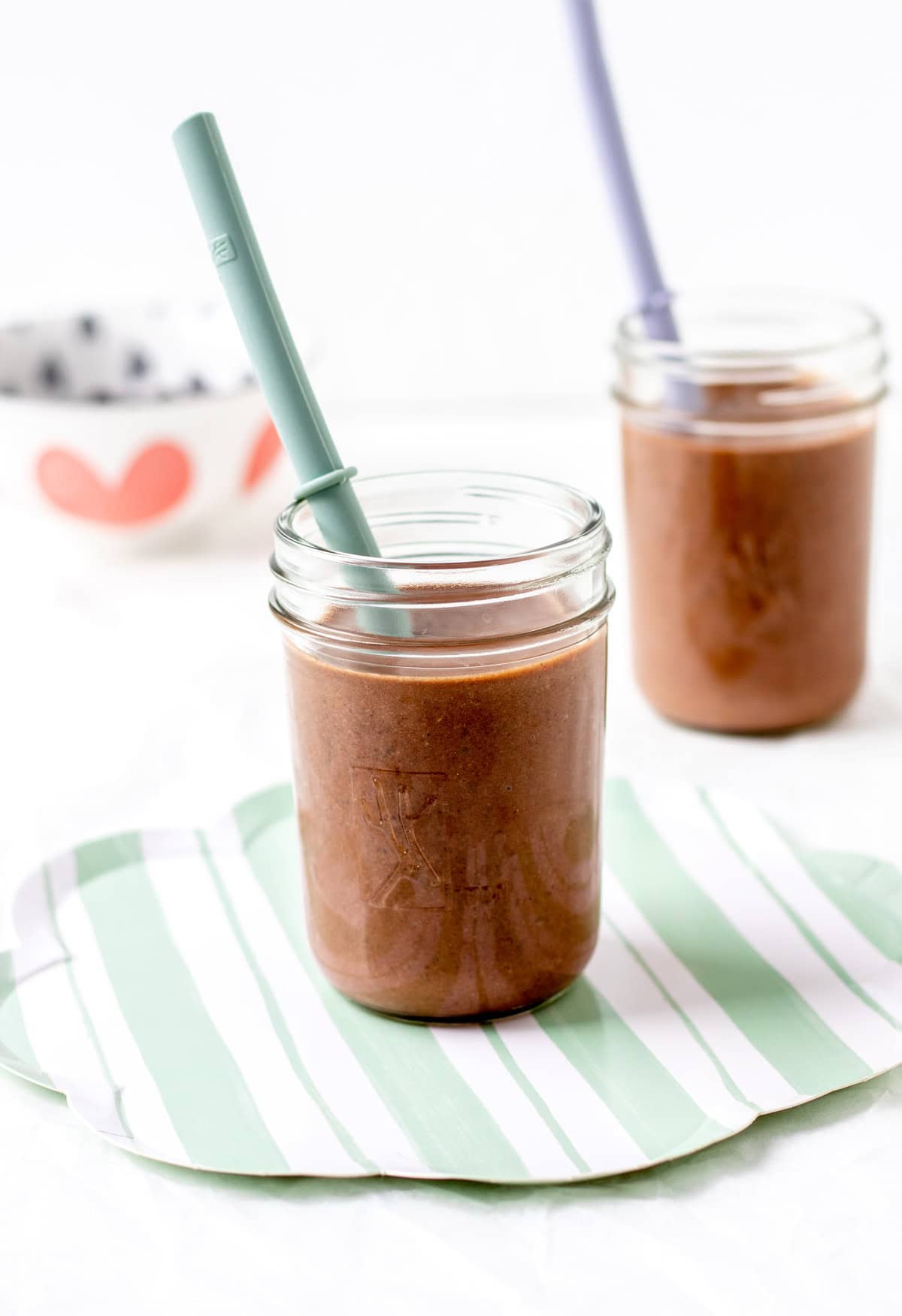 Two chocolate black bean smoothies on a counter.