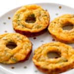 Side view of broccoli and cheese egg donuts on a polka dot plate.