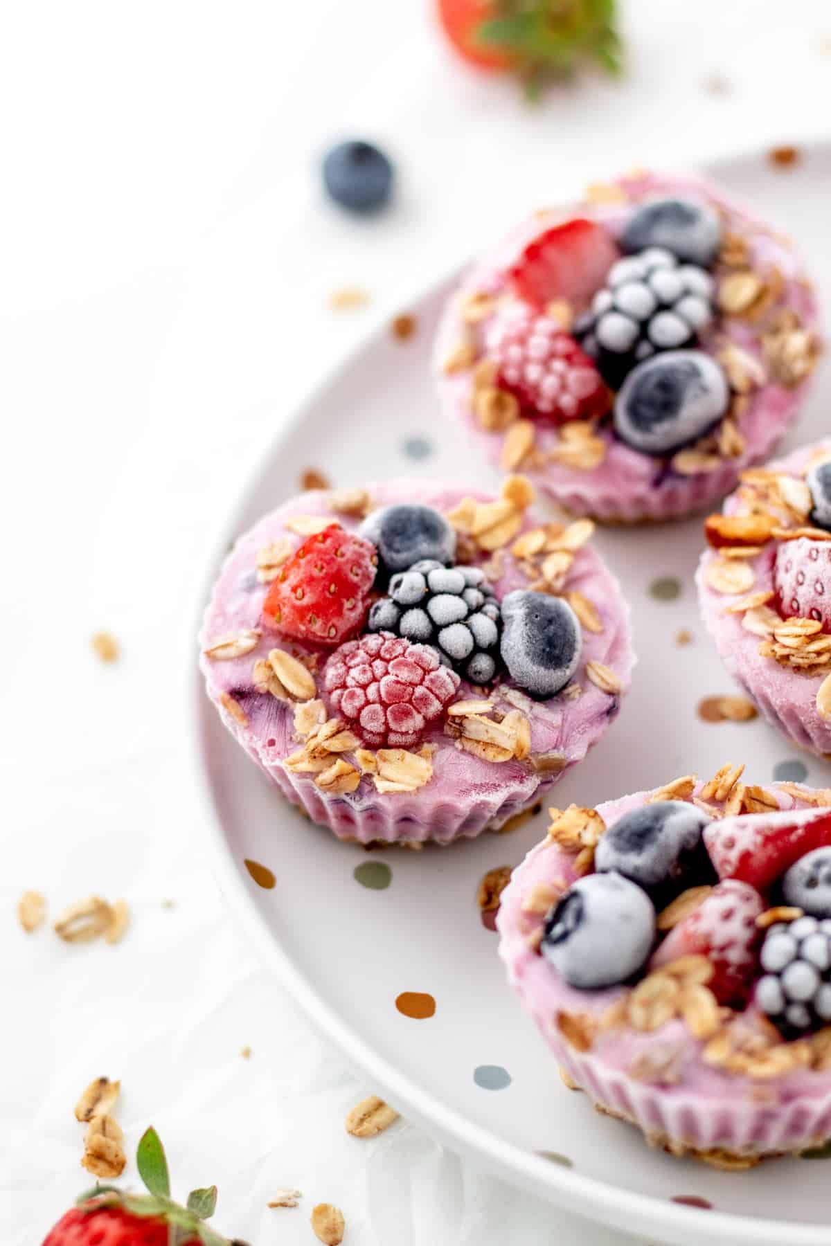 A close-up of frozen Greek yogurt bites on a polka dot plate.