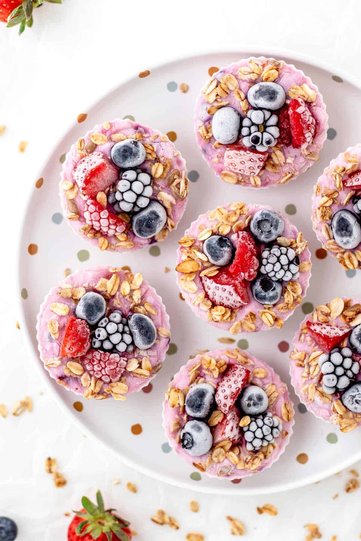 A birds-eye view of frozen Greek yogurt bites on a polka dot plate.