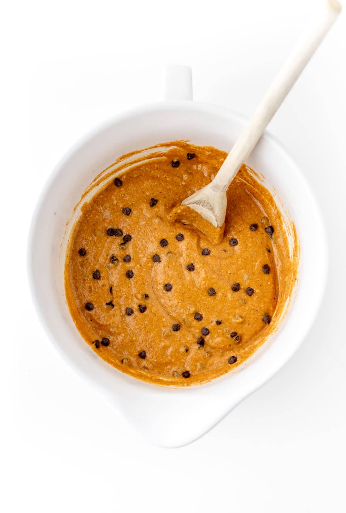 Add mini chocolate chips to the pumpkin muffin batter.