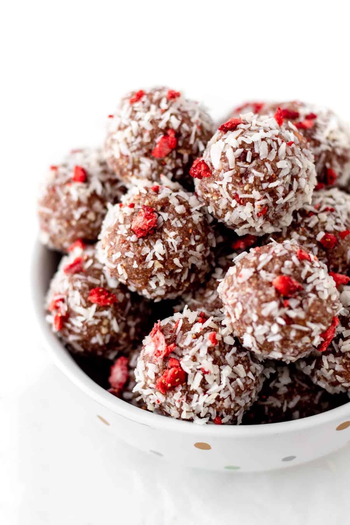 A close-up of strawberry bliss balls in a bowl.