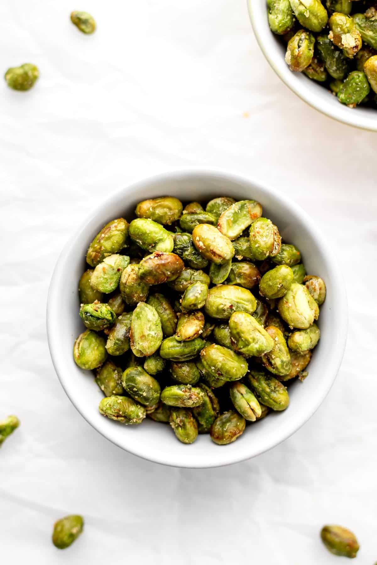 A birds-eye view of air fryer edamame in a bowl.