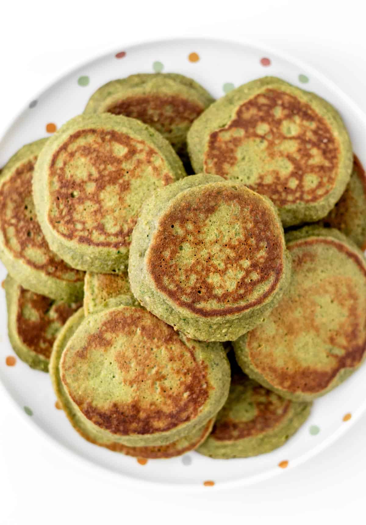 A close-up of hulk pancakes stacked on a decorative plate.