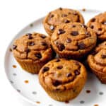 Pumpkin peanut butter muffins stacked on a polka dot plate.