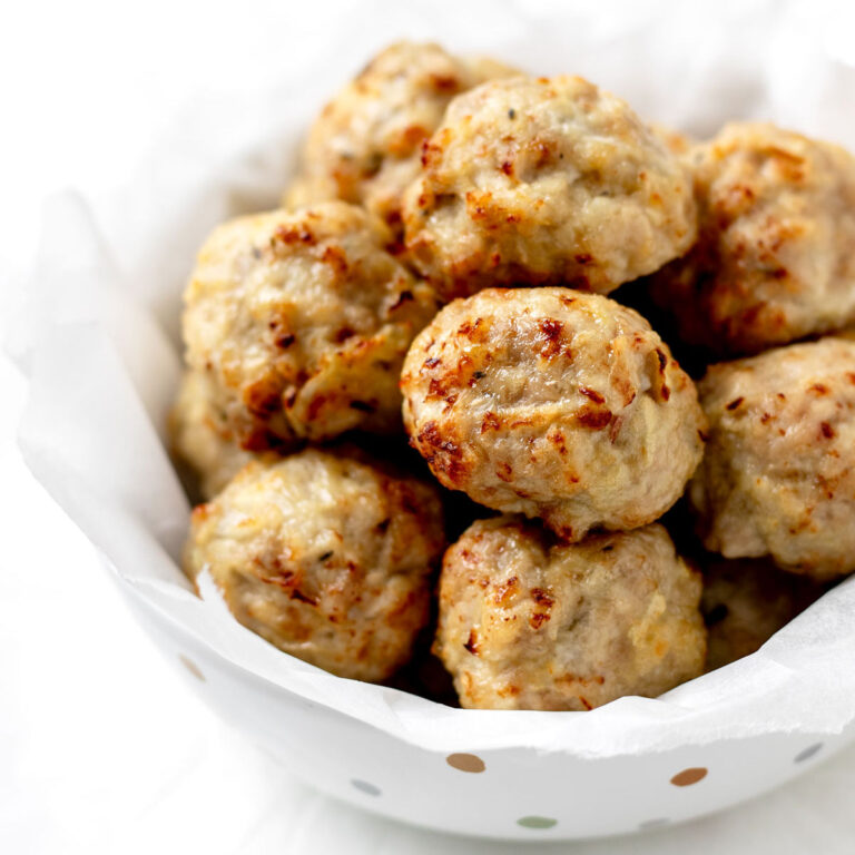 Apple chicken meatballs stacked in a polka dot bowl.