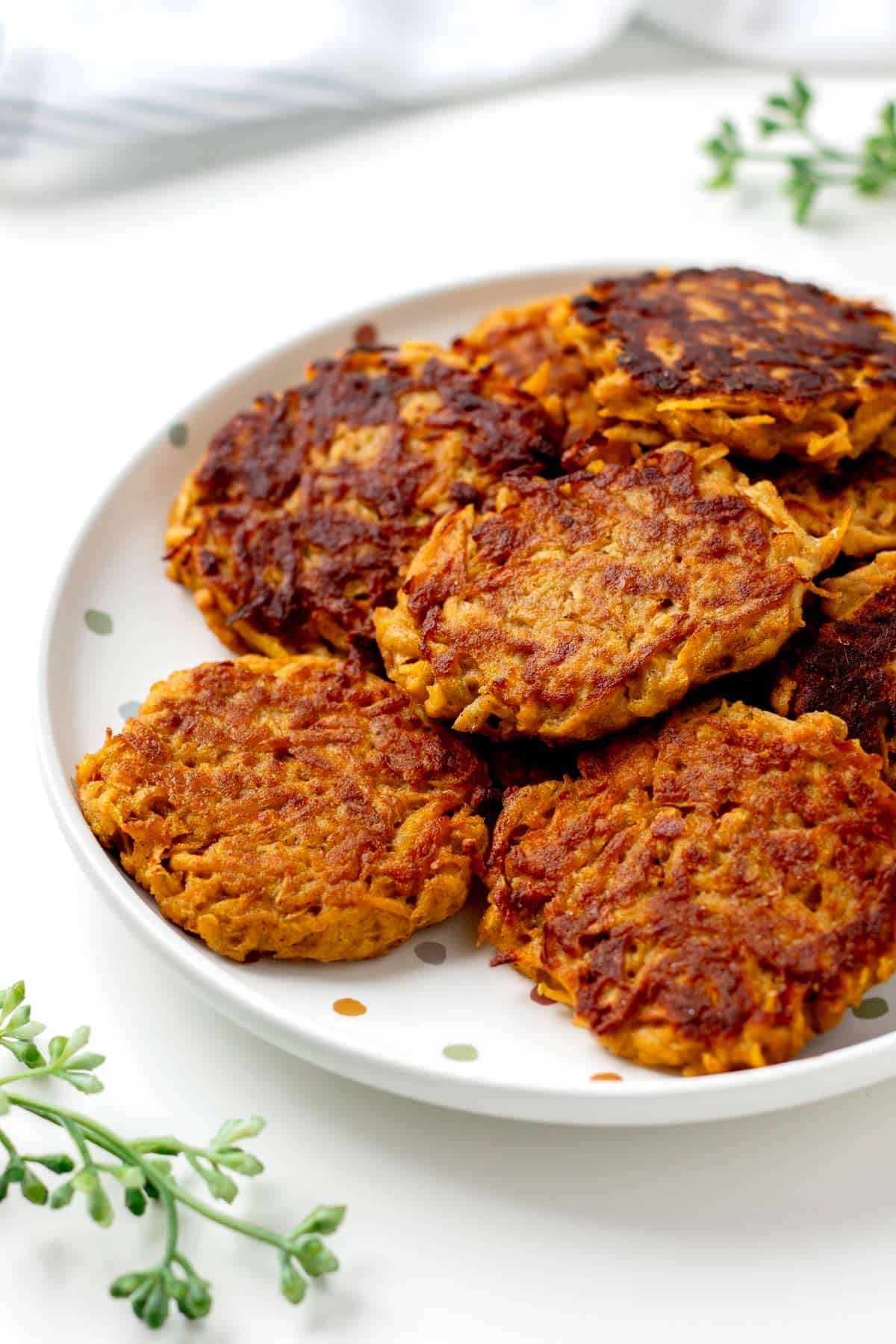 Butternut squash patties on a polka dot plate on the table.